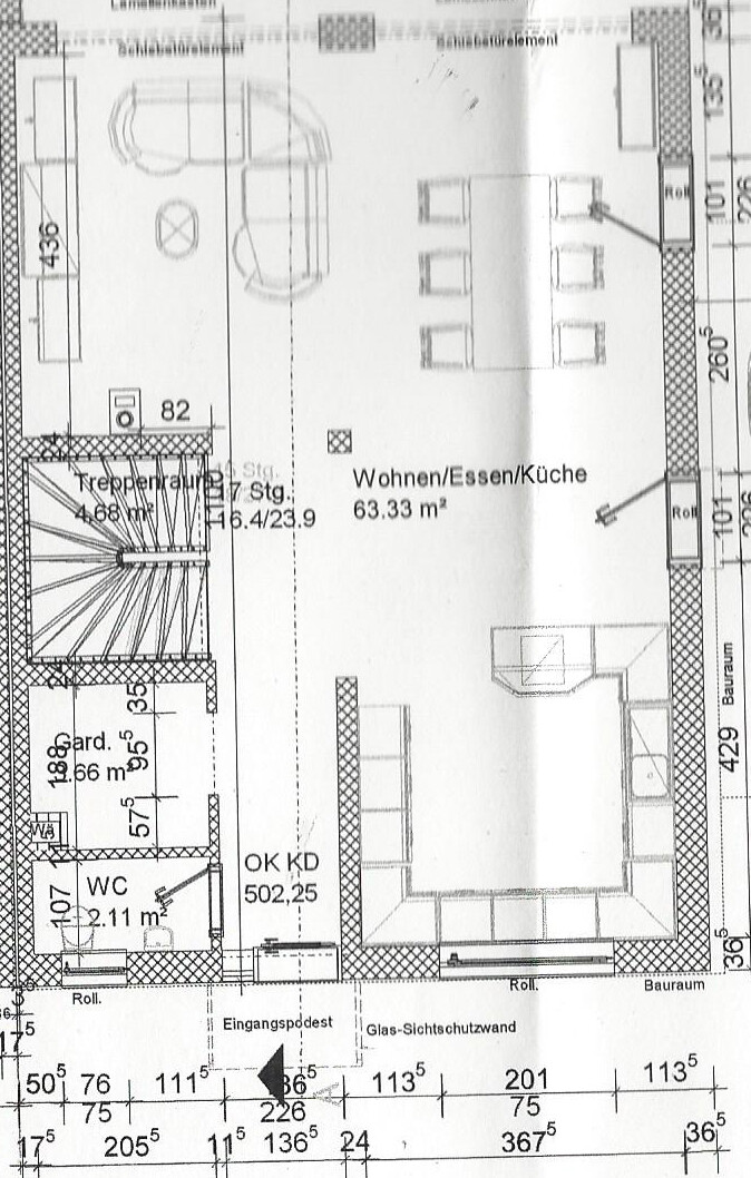 Floor plan of a house with living, dining, kitchen areas and staircase.