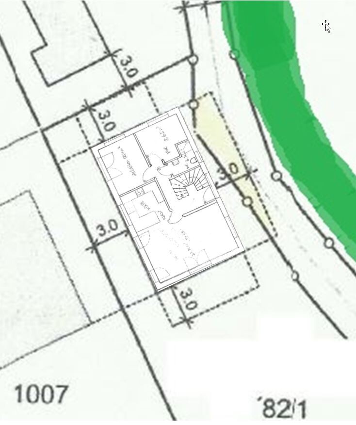 Two-dimensional house floor plan with interior layout and surrounding green area.