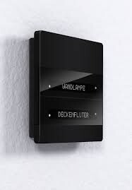 Black modern wall light switch with display on white wall