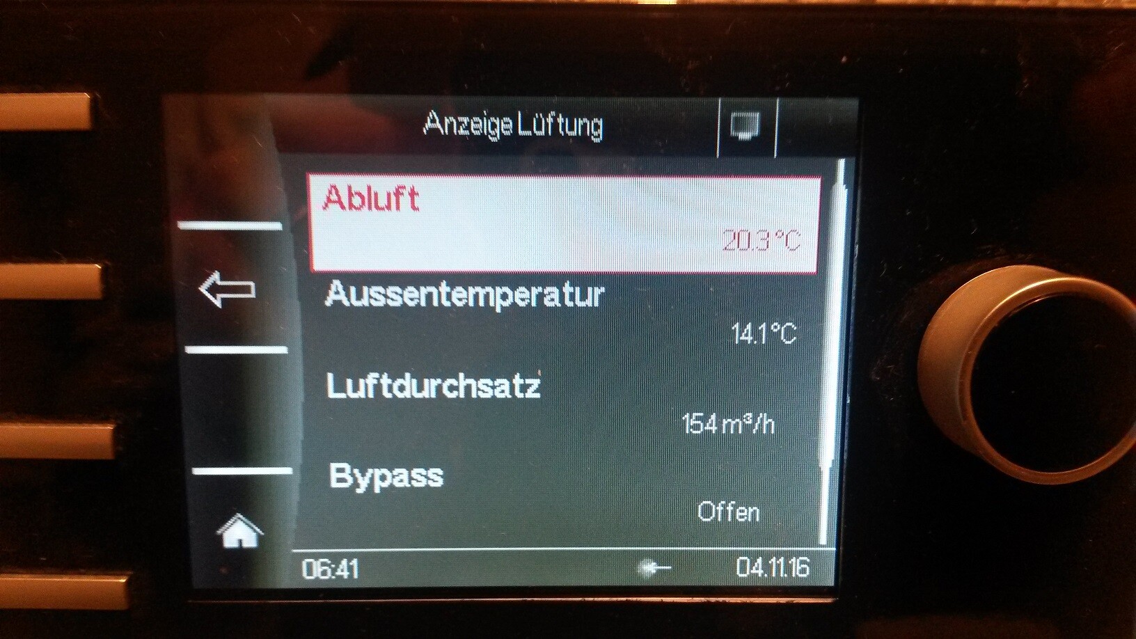 Control panel of a ventilation system showing exhaust air, outside temperature, and airflow.
