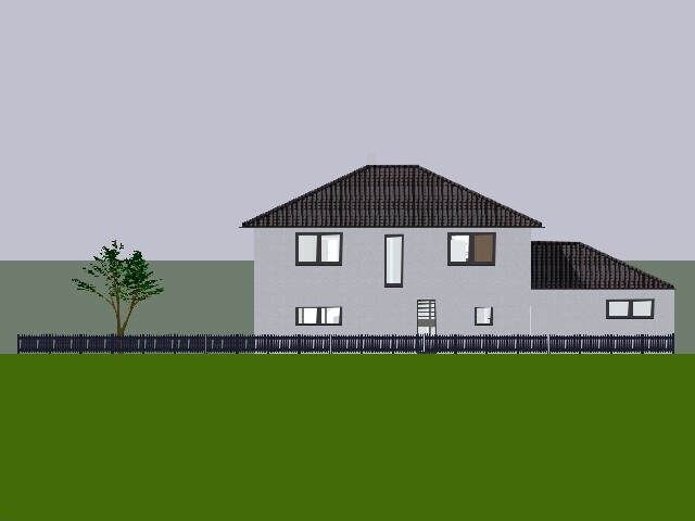 Zweistöckiges graues Wohnhaus mit dunklem Dach, Seitenanbau, Zaun, Baum links, grüne Wiese.