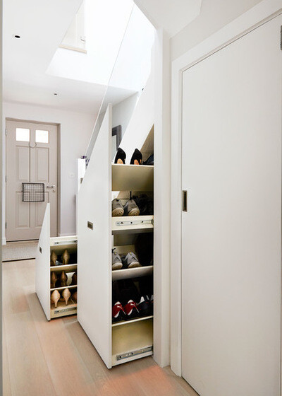 Bright entrance area with white shoe cabinets in the hallway and door at the end