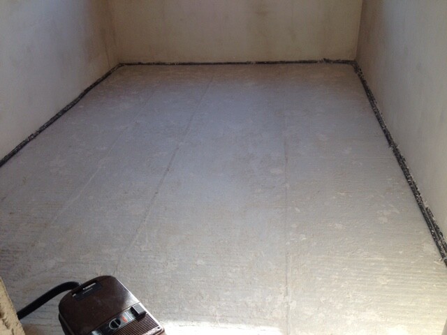 Unprocessed interior with raw concrete floor and untreated walls in shell condition.