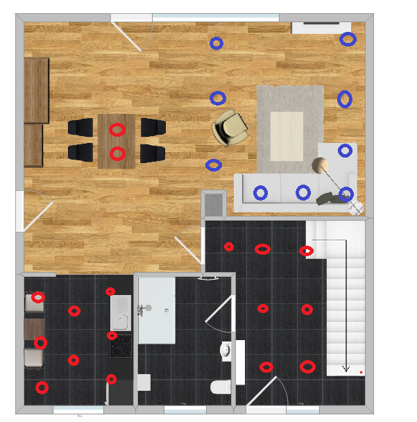 2D floor plan of a living and dining area with kitchen, dining table, and staircase