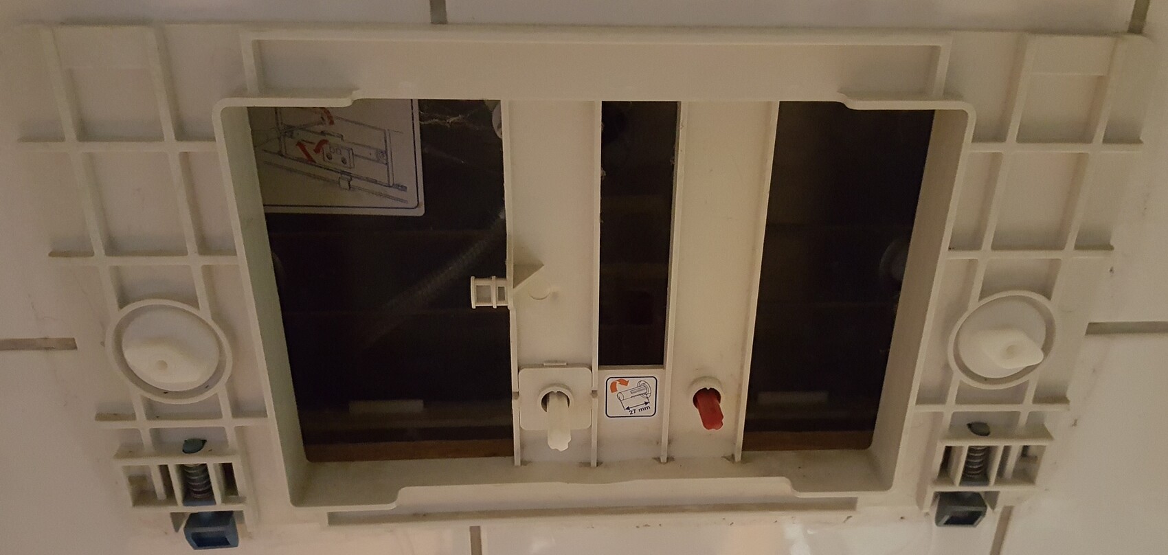 Close-up of a flush-mounted electrical junction box with connectors and sliders