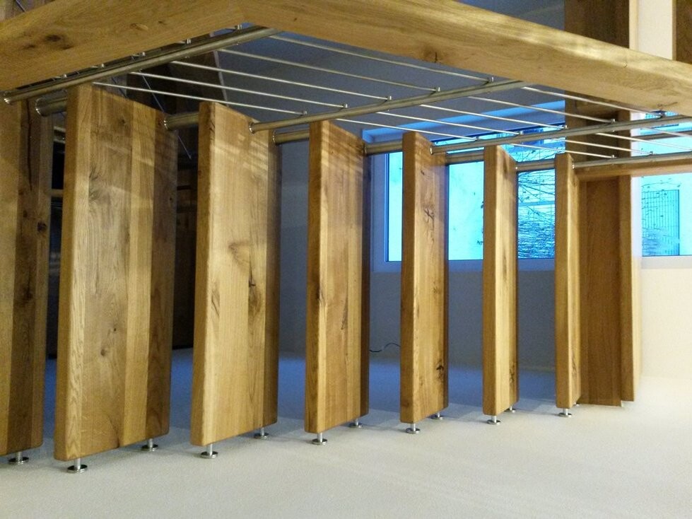 Several vertical wooden panels forming a room divider inside, with metal beams above.