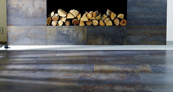Modern living room with fireplace, firewood, and dark gray wooden floor
