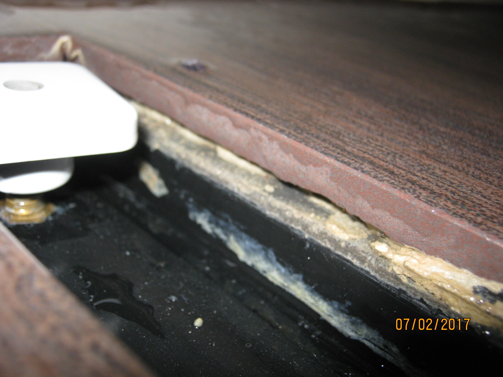 Close-up of parquet edge with insulation foam between floor covering and substructure