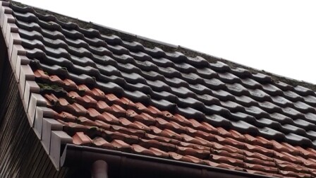 Close-up of brown and red roof tiles at a roof edge