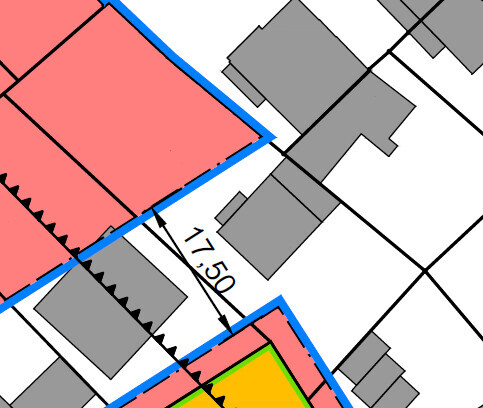 Site plan of a building lot with blue outline, red buildings and gray structures.