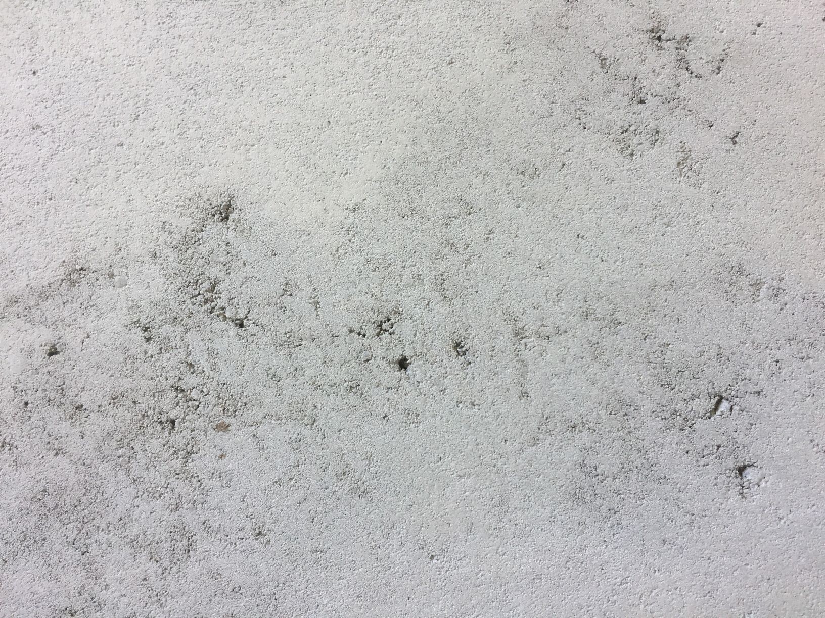 Rough concrete wall surface with texture and unevenness