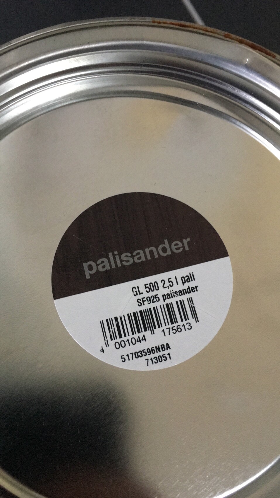 Close-up of a metal can with Palisander color label and barcode