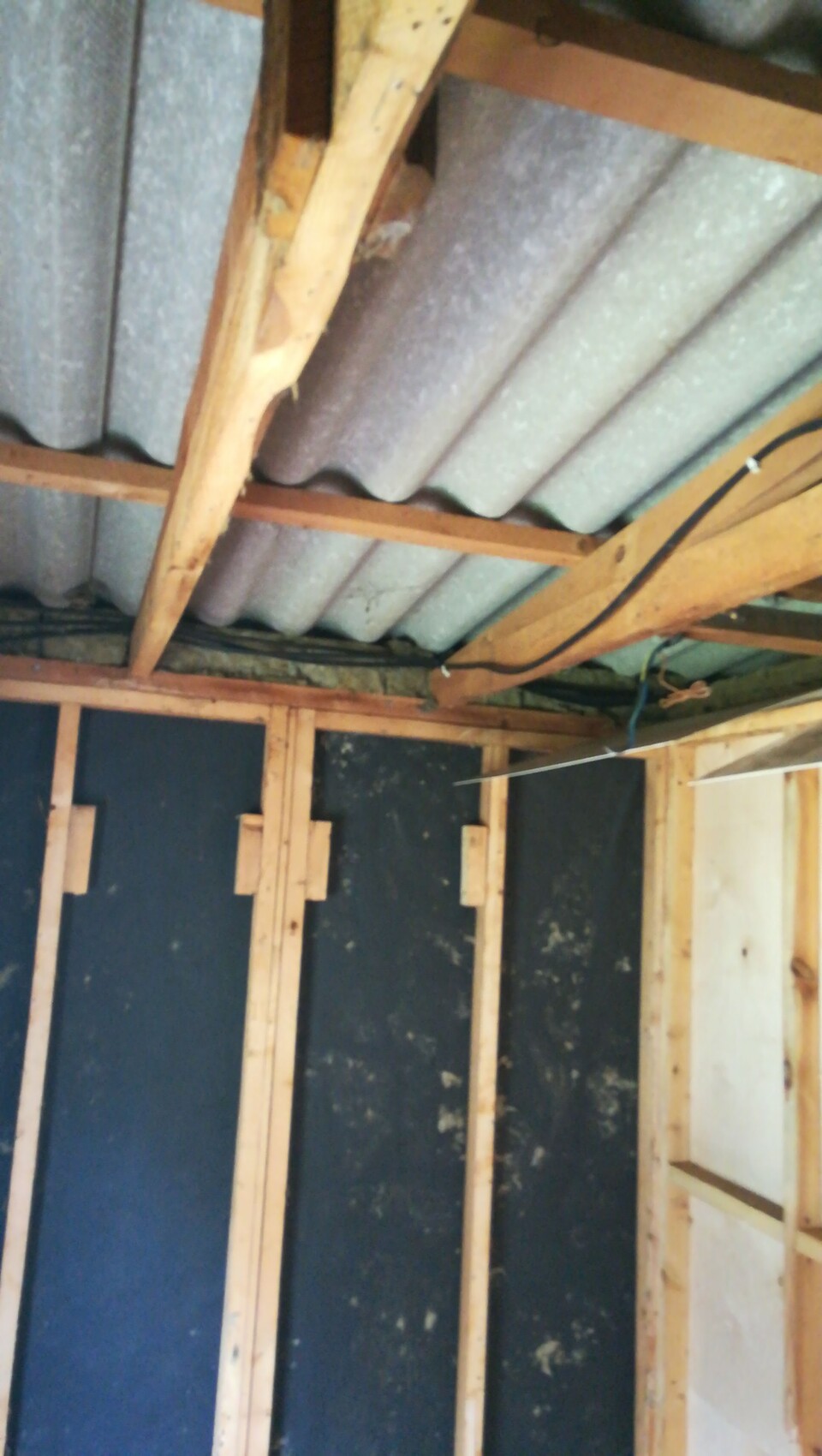 Shell interior with wooden frame, roof beams and visible cables