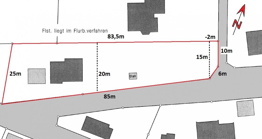 Site plan of a property with red outline, dimensions and buildings