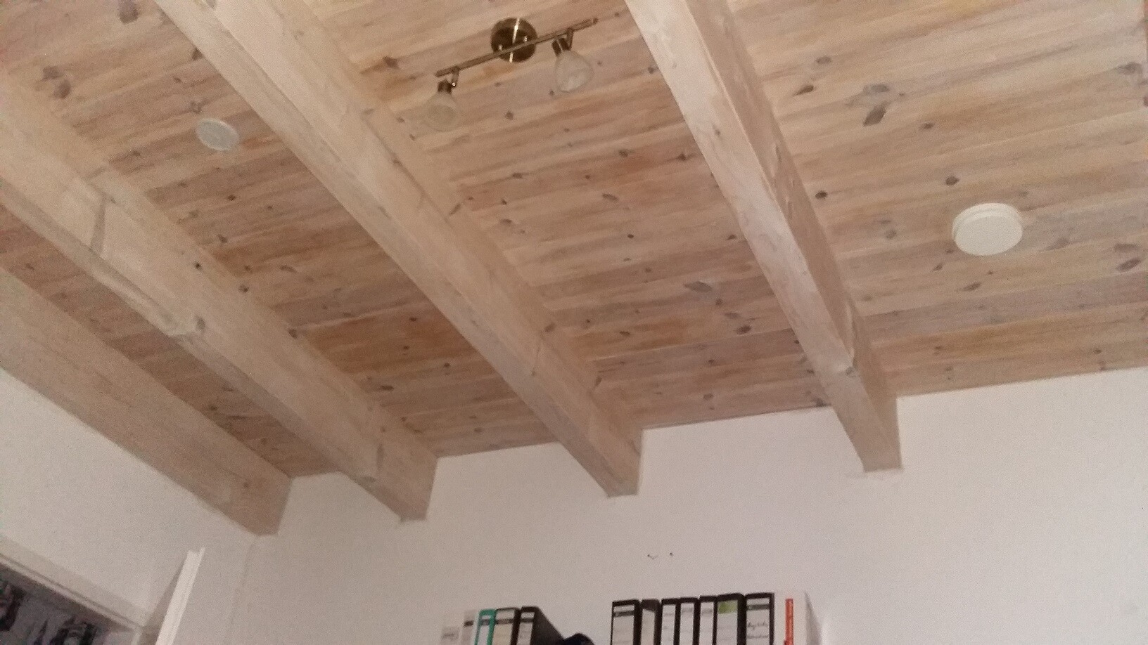 Visible wooden beam ceiling with ceiling light indoors
