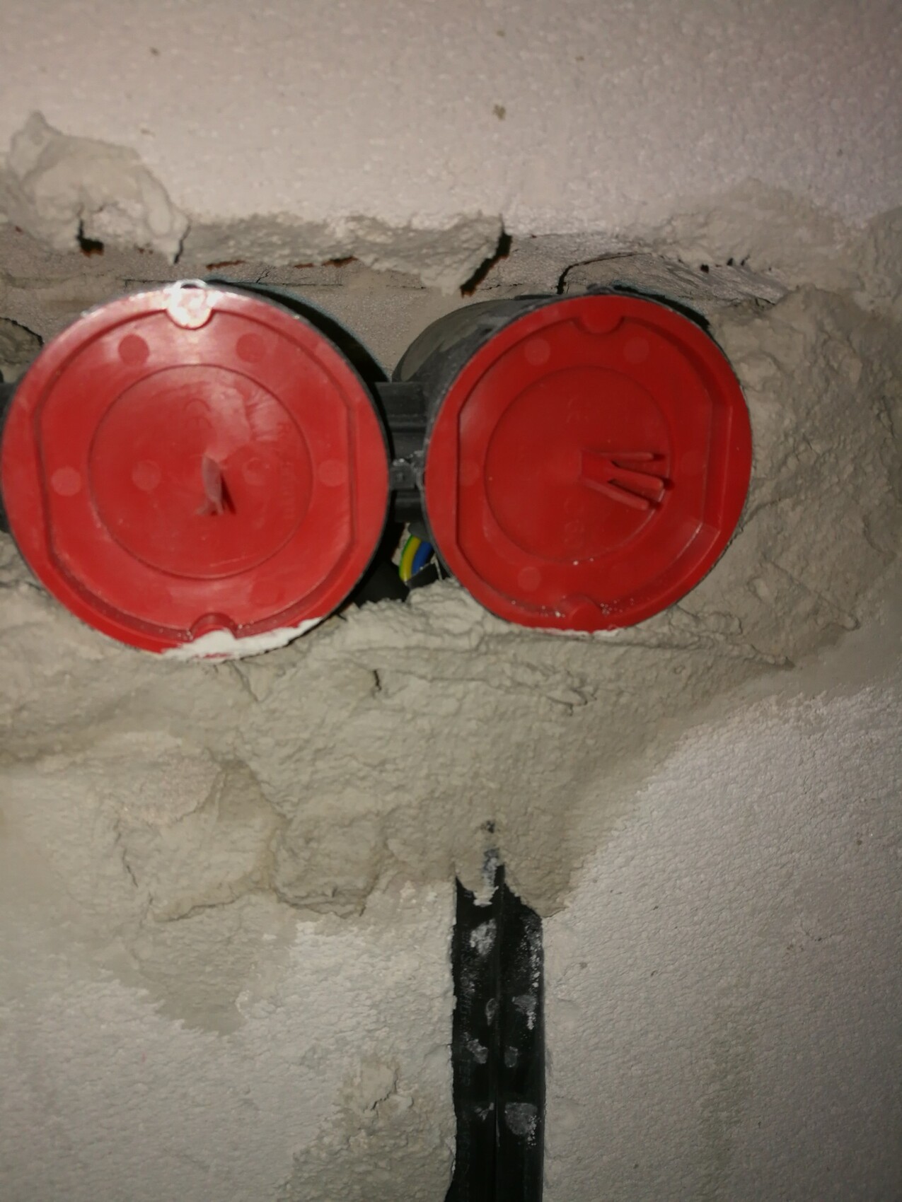 Red round electrical boxes in the shell construction with visible cables