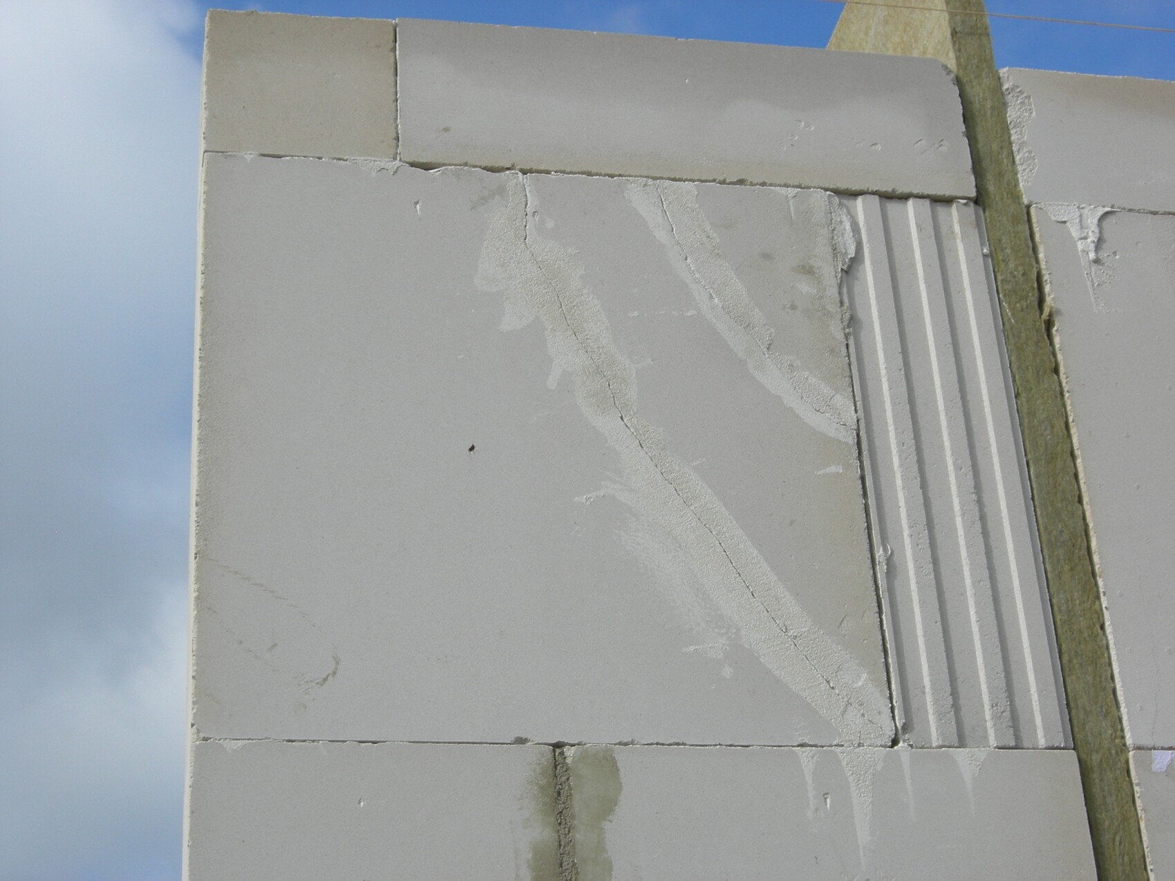 Close-up of a concrete wall under construction with blocks and grooves