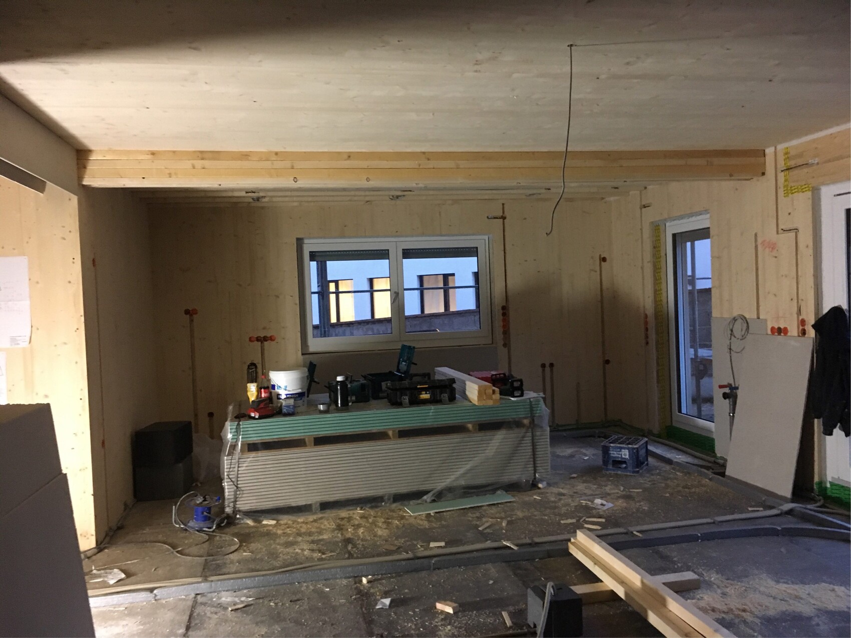 Innenausbau-Baustelle mit Werkbank, Holz, Werkzeugen in halbfertiger Wohnung