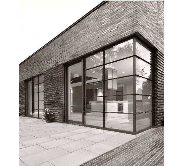 Modern brick facade with large glass fronts on a house