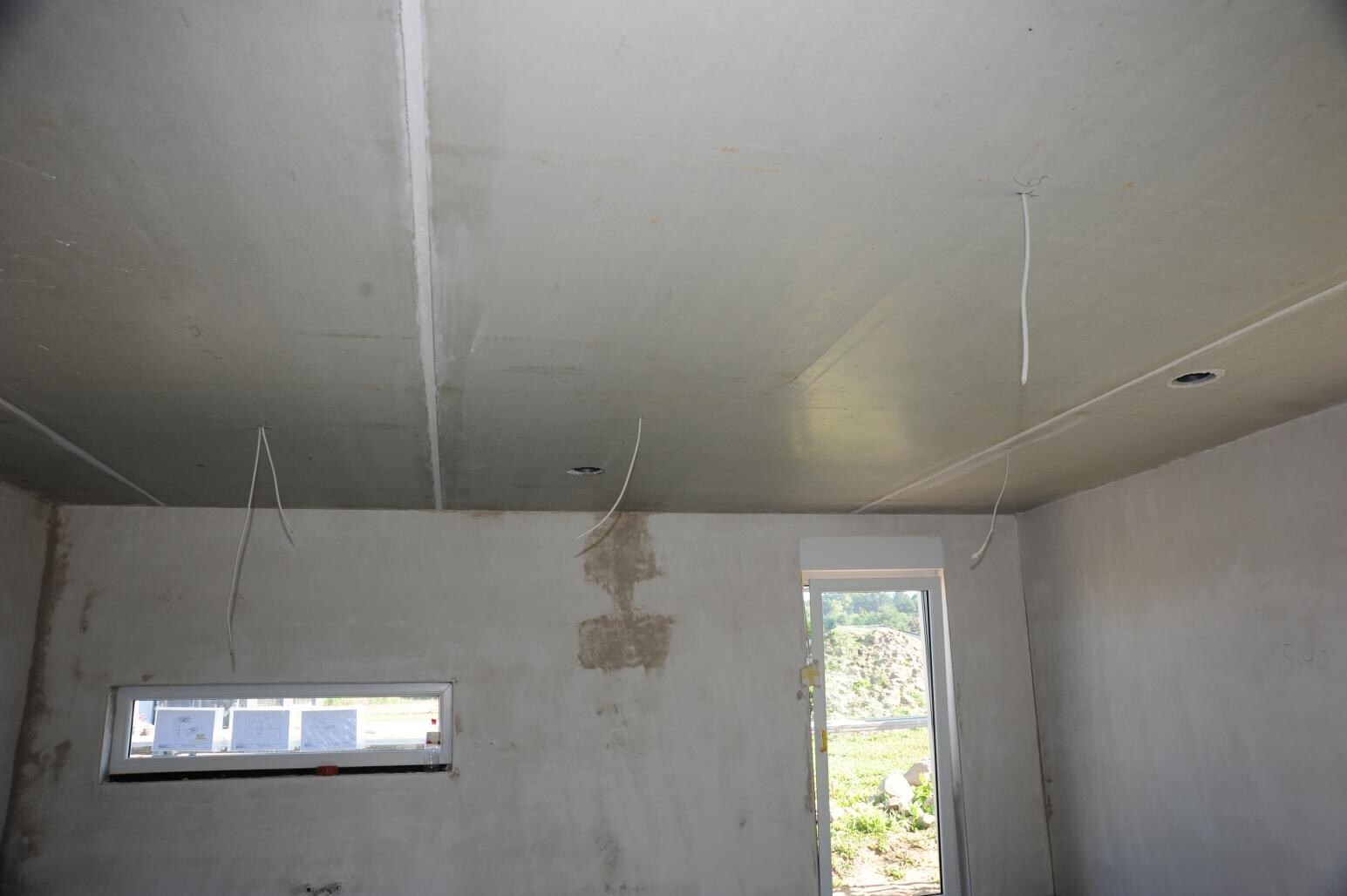 Shell stage interior with open door, exposed wiring running from the ceiling