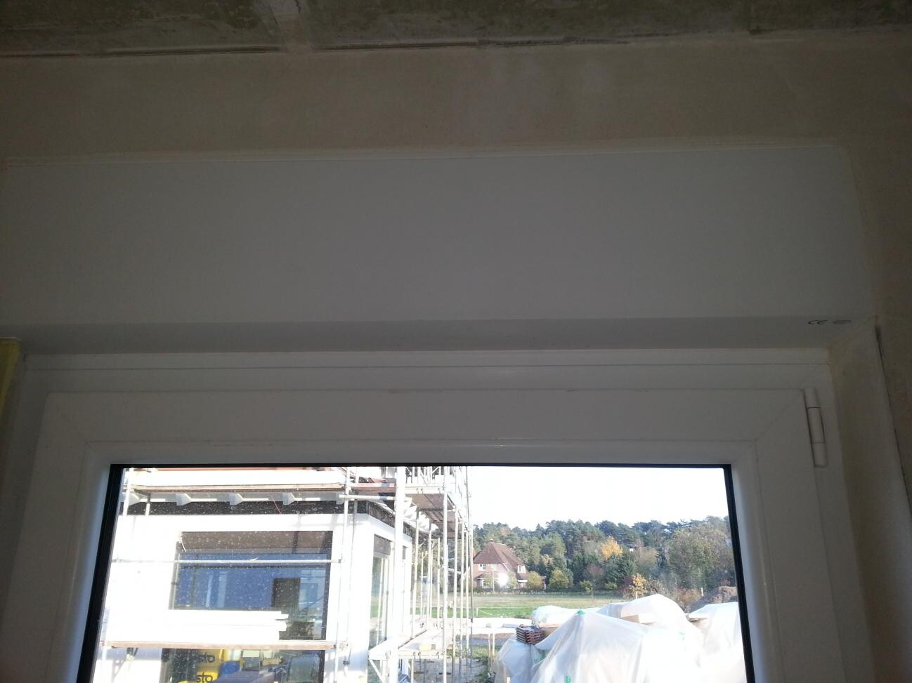Interior view of a window at shell stage, looking out onto the construction site
