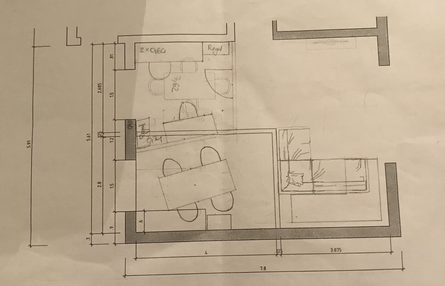 Floor plan of living and dining area with dining table, chairs, and sofa