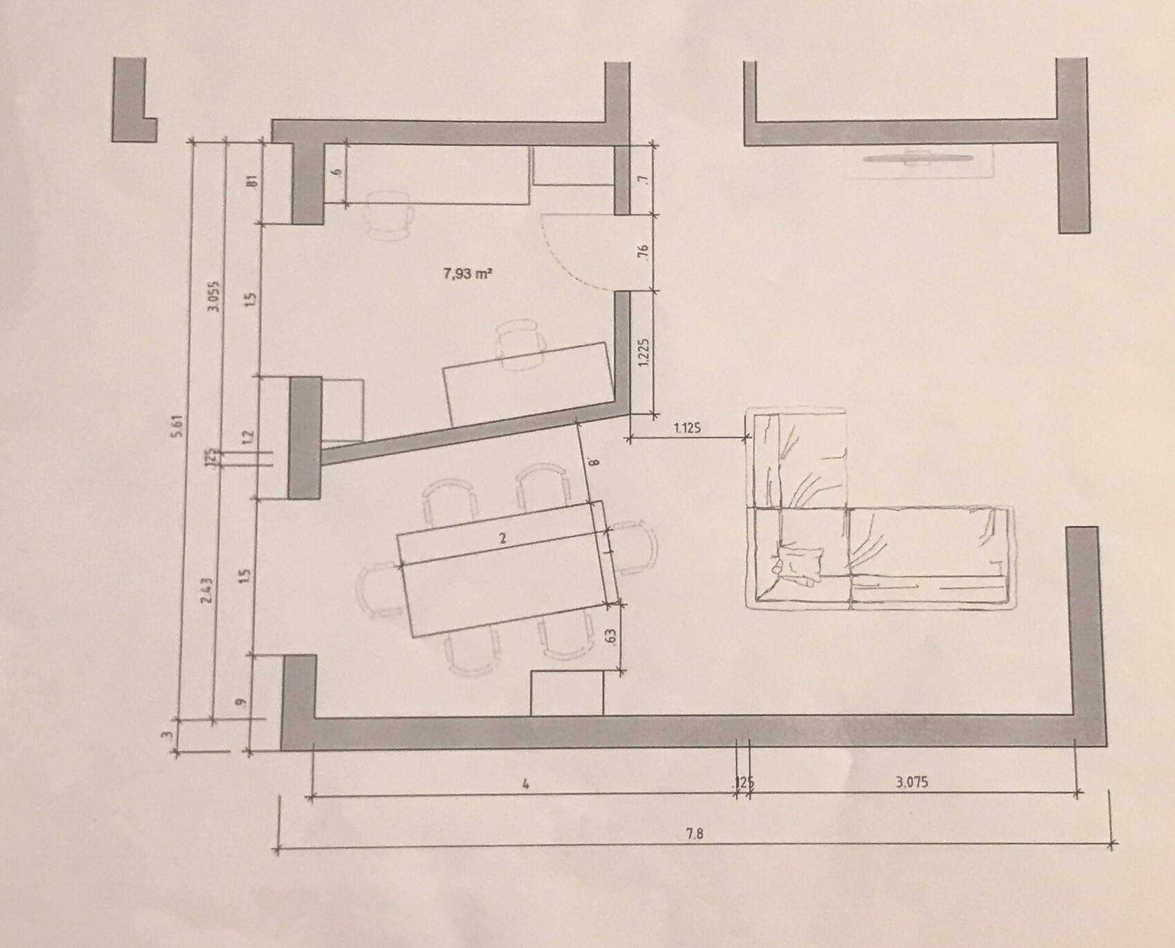 Floor plan of a living room with sofa and dining table in an open layout.