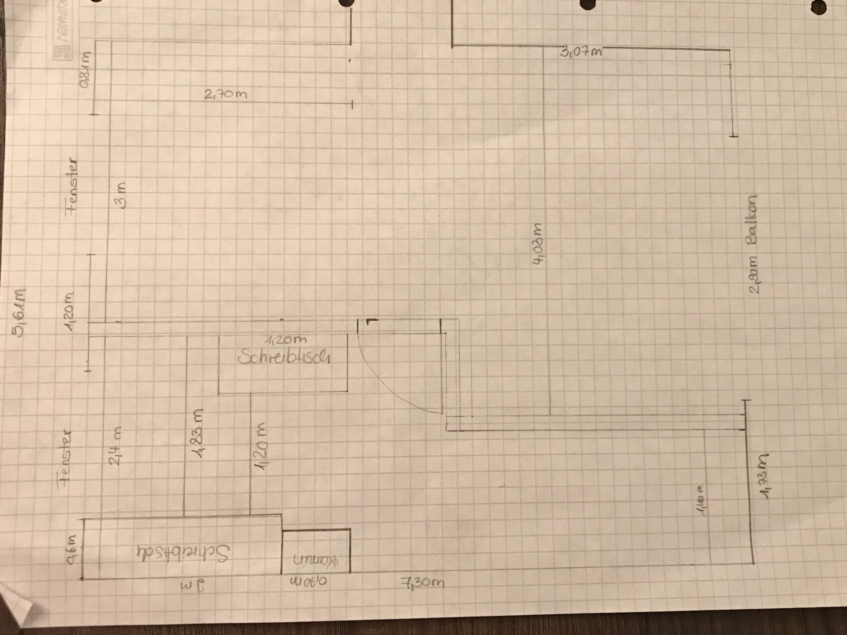 Hand-drawn floor plan of an apartment with desk area, doors and balcony