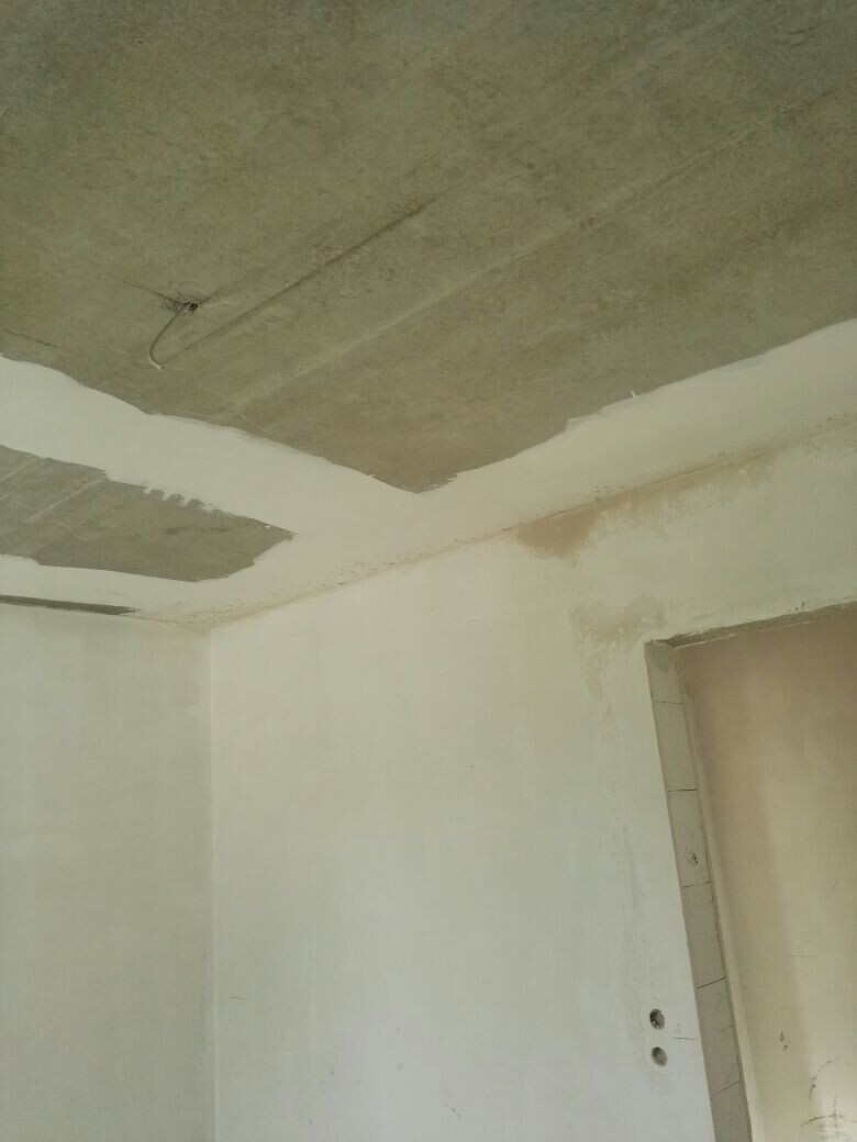 Unfinished interior with raw concrete ceiling and untreated walls in construction condition