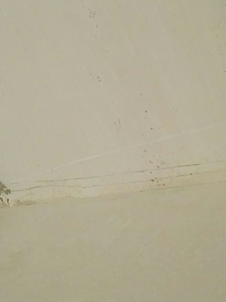 Beige wall surface with minor cracks and scratches