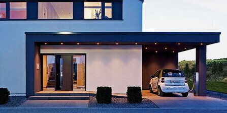 Modern front view of a house with carport, large glass façade, and entrance door.