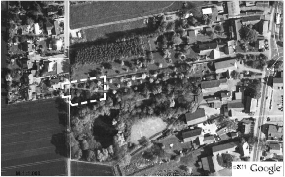 Aerial view of a plot with surrounding neighborhood, trees, and streets.
