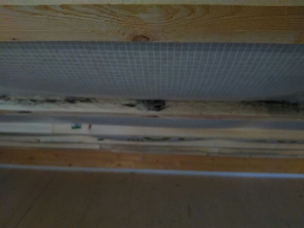 Construction phase with wooden beams, insulation, and interior sheathing boards