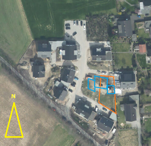 Aerial view of a new development area with lot boundaries and houses marked in orange and blue