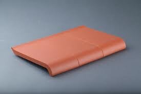 Curved terracotta roof tile made of clay, orange-red
