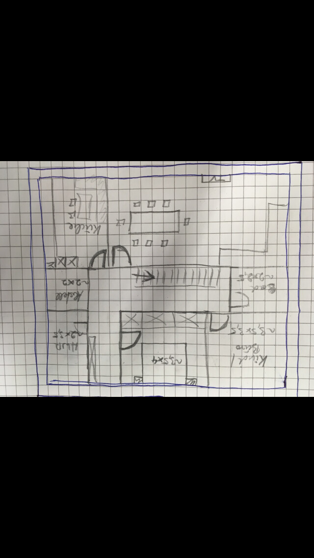 Hand-drawn floor plan sketch of a house with interior walls on graph paper