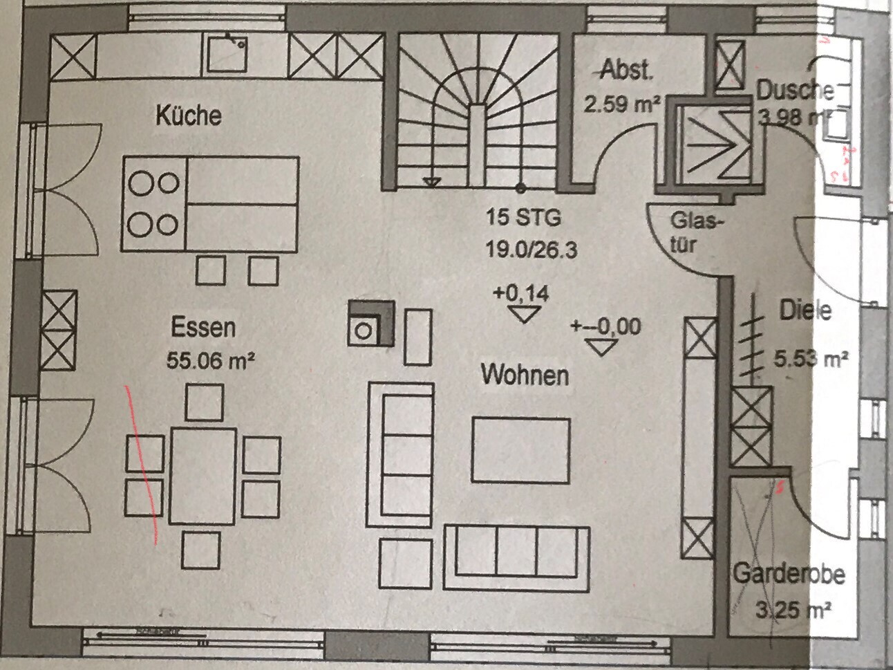 Floor plan of open living, dining, and kitchen area with stairs, storage room, and shower.