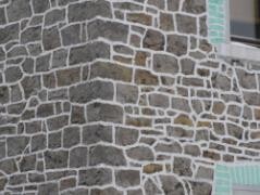 Außenansicht eines Hauses mit Steinfassade und Fenster