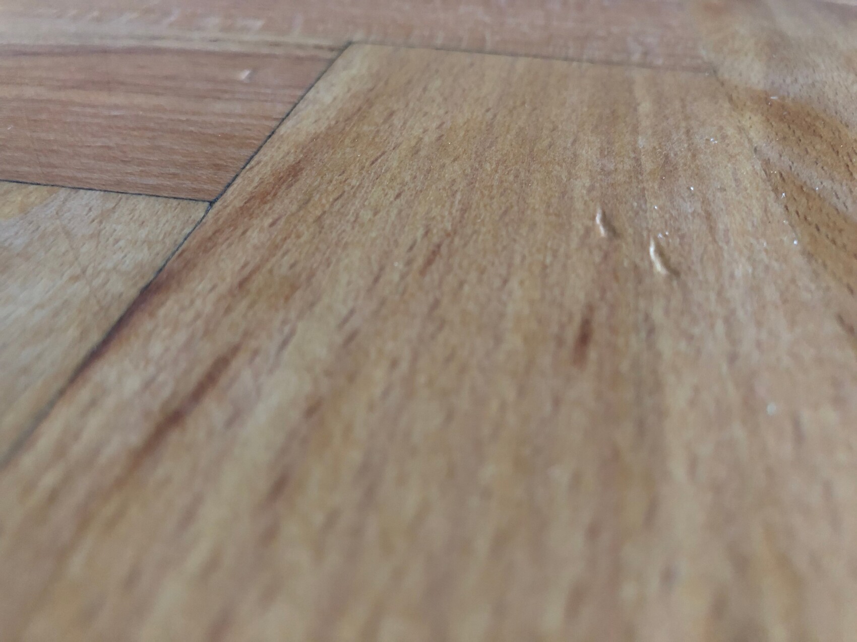 Close-up of wooden floorboards with grain and warm wood color