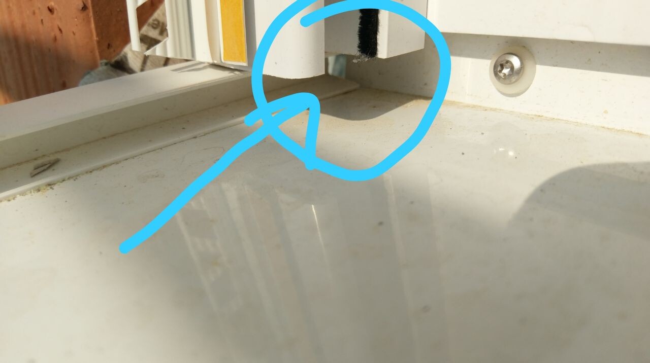 Gap at window frame, marked in blue, visible on the window sill.