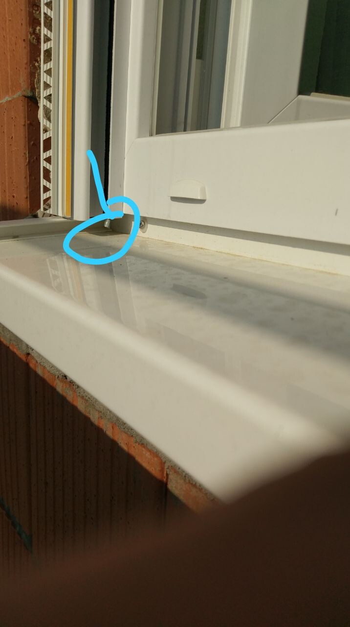 White window frame and window sill with a small gap at the bottom edge of the window opening.