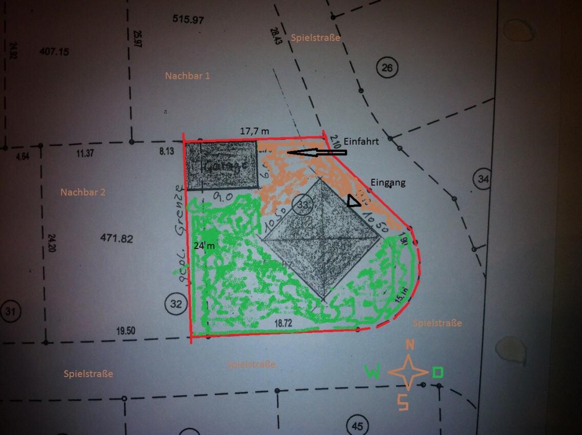 Site plan of a plot with house floor plan, driveway, and garden areas