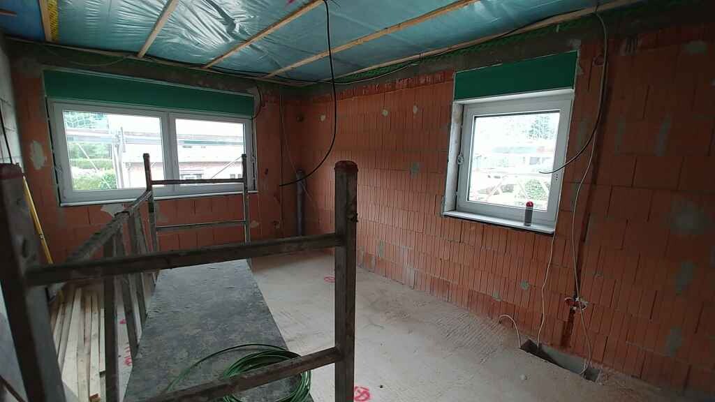 Unfinished interior in shell construction with brick walls, windows and installations