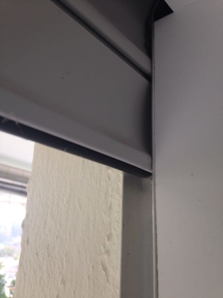 Close-up of a roller shutter window with metal frame and slats