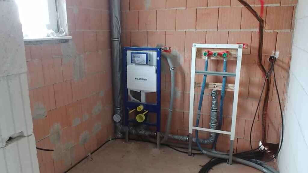 Bathroom shell with sanitary frame and installation pipes
