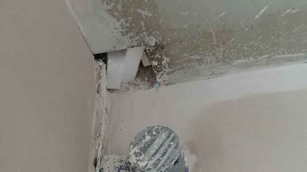 Damaged wall with peeling plaster during renovation