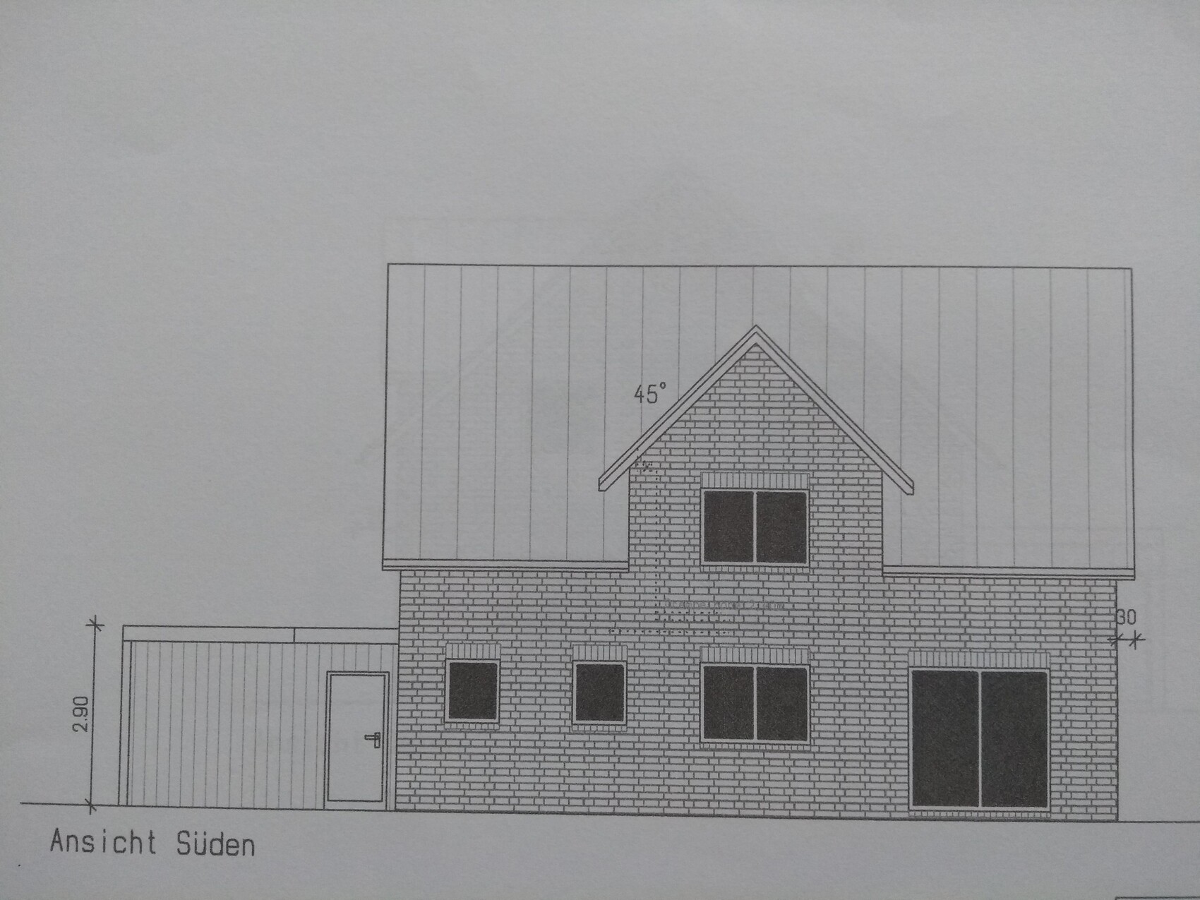 South elevation of a two-story brick house with gable roof, garage on the left and large windows on the right.