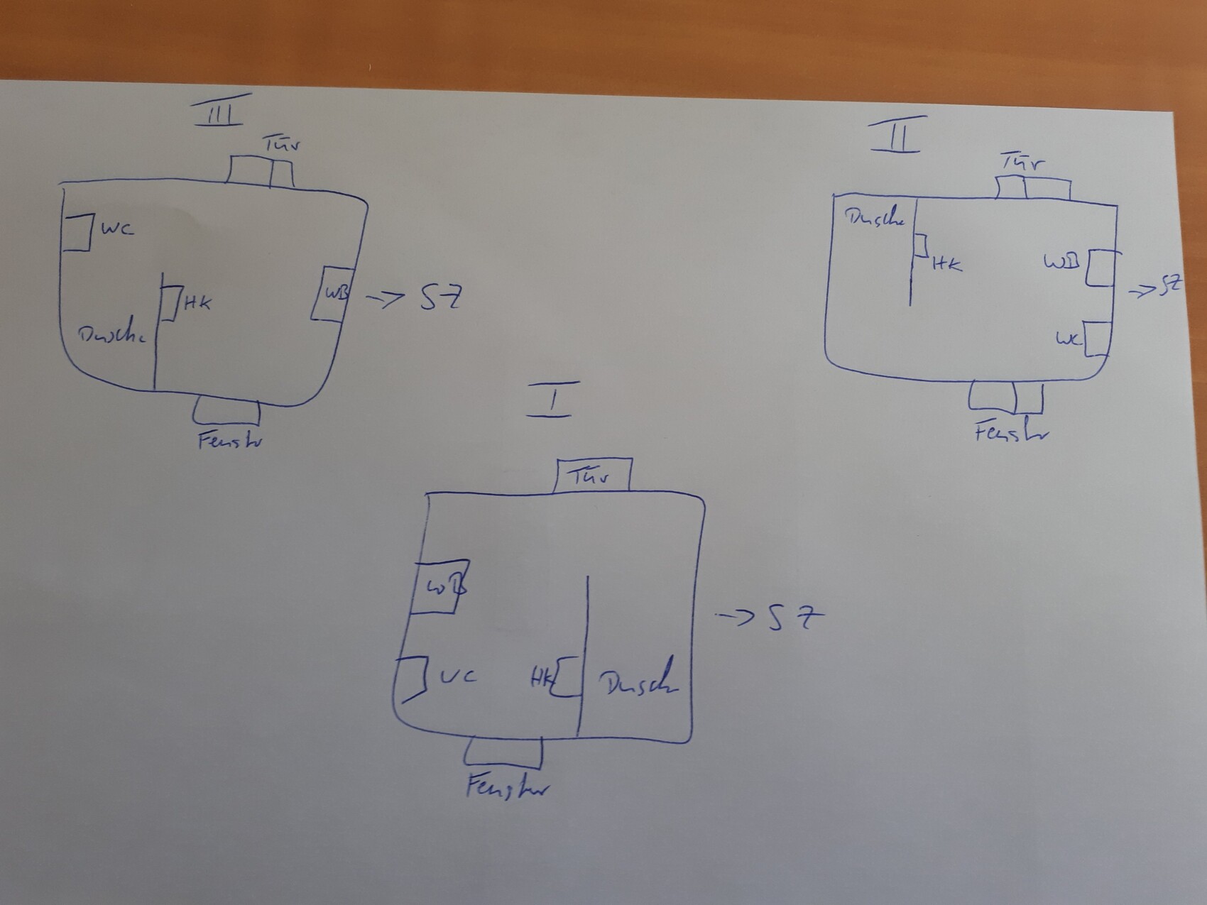 Sketches of a floor plan with toilet, shower, doors, windows, and labels.
