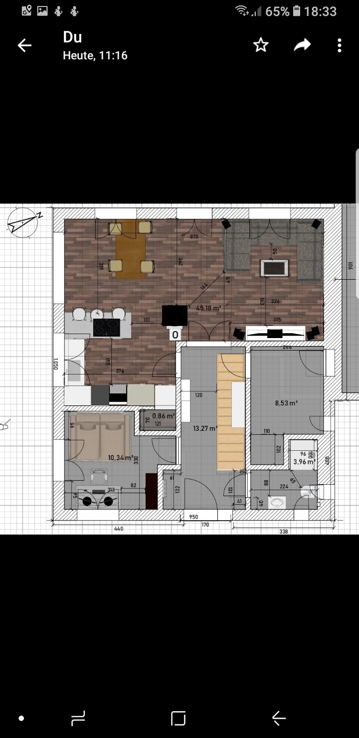 Floor plan of an apartment: kitchen with island, dining table, living room, bedroom bottom left.