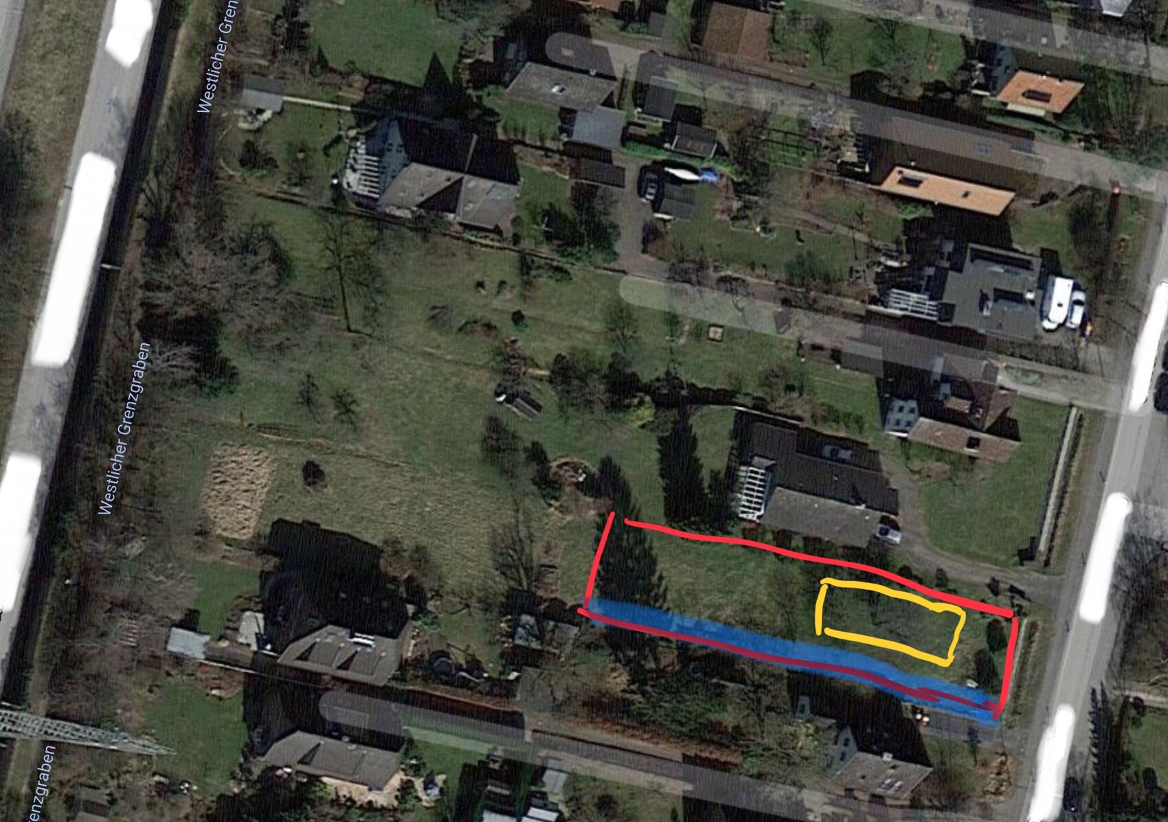 Satellite image of a residential area with garden and marked plot areas